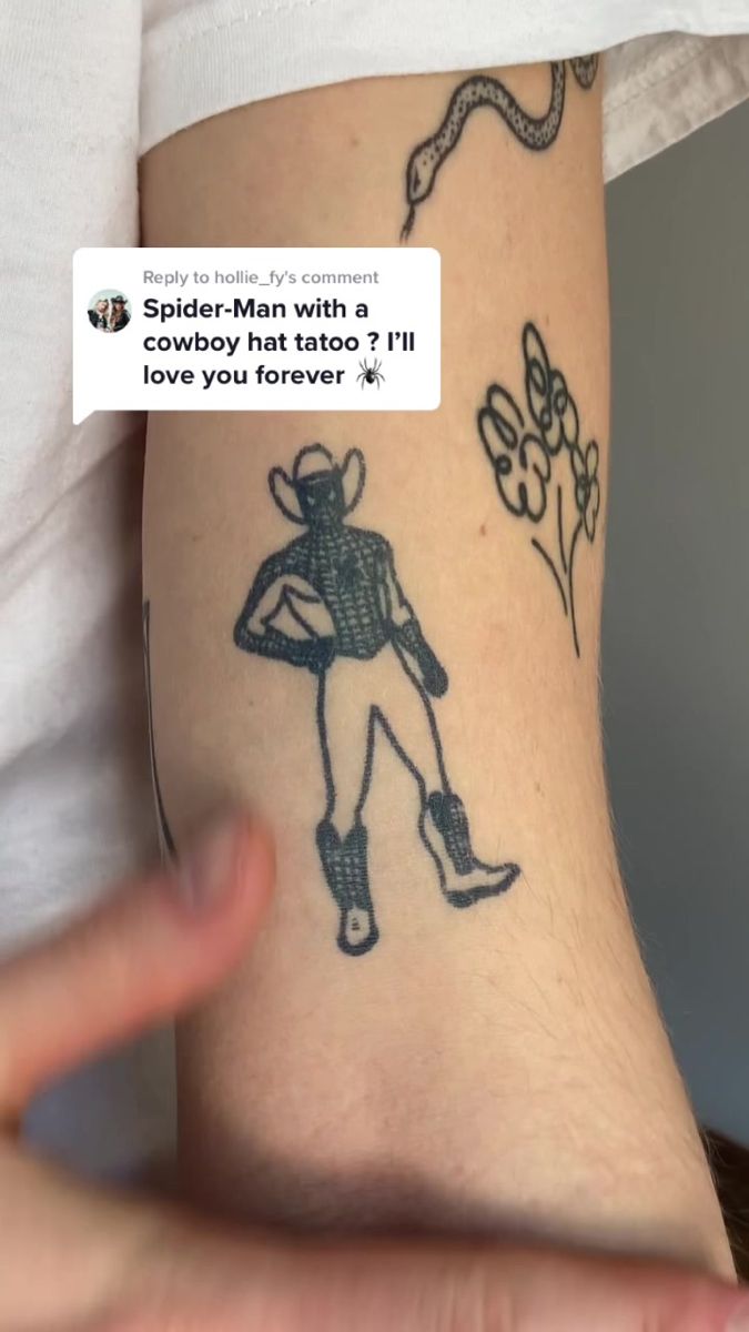 a person with a spider - man tattoo on their arm and the caption reads,'spider - man with a cowboy hat & i '