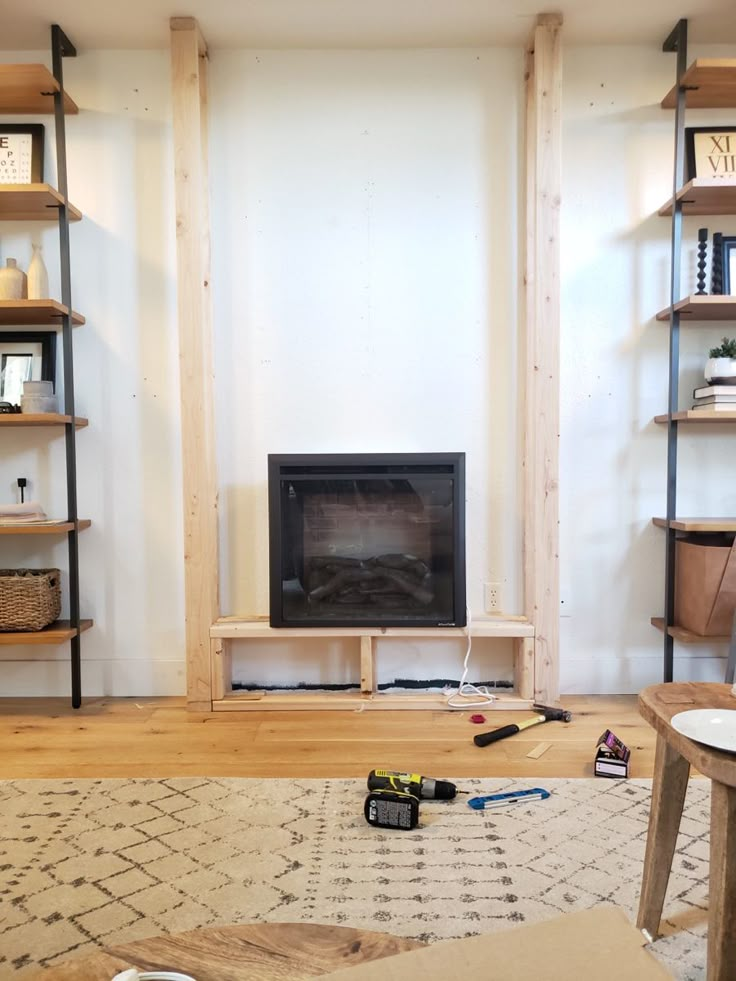 a living room filled with furniture and a flat screen tv mounted on a wall above a fire place