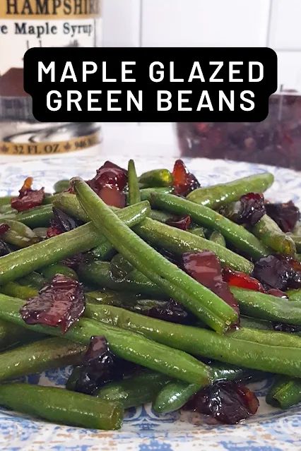 green beans are piled up on a blue and white plate with the words maple glazed green beans