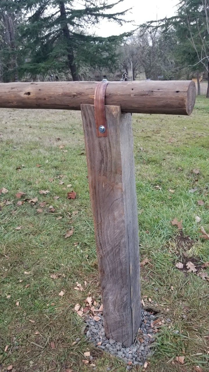 an old wooden pole in the middle of a field