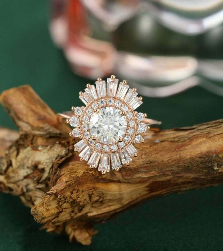 a diamond ring sitting on top of a piece of wood