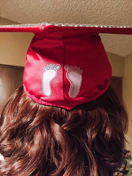 the back of a woman's head wearing a red graduation cap