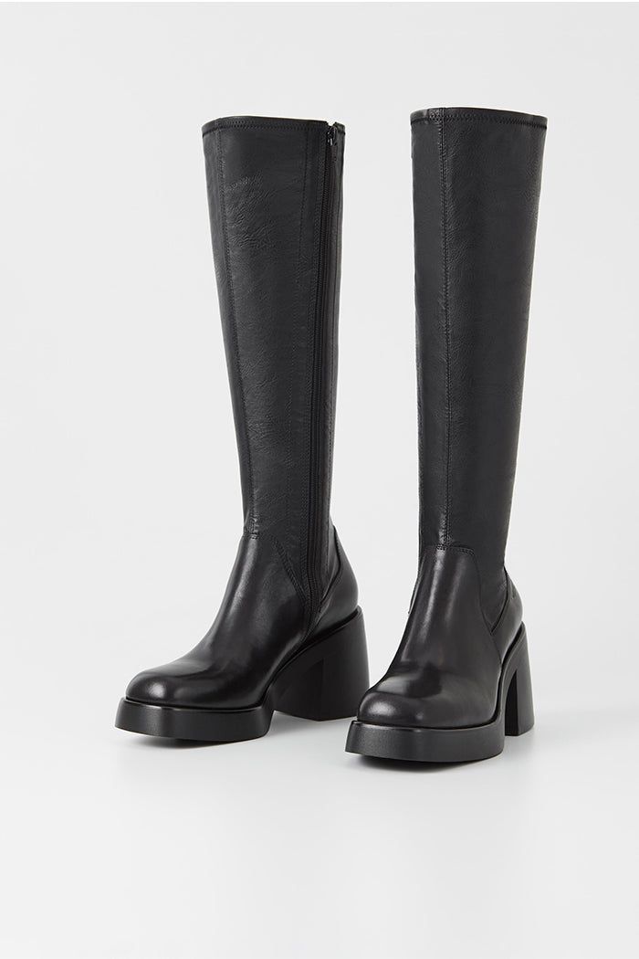 Vagabond Brooke knee high tall black leather boots with platform. Retro-inspired design is crafted from black leather featuring a stretchy shaft, square toes and inside zippers. The chunky rubber outsoles is paired with 87mm block heels. 5044-002-20 Block Heeled Black Boots, Black Boots Bridesmaid, Black Heeled Boots Uk, Black Trench Black Boots, Luxury Black Classic Mid-calf Boots, Luxury Black Leather Mid-calf Boots, Luxury Vintage Black Boots, Black Boots H&m, Black High Ankle Boots