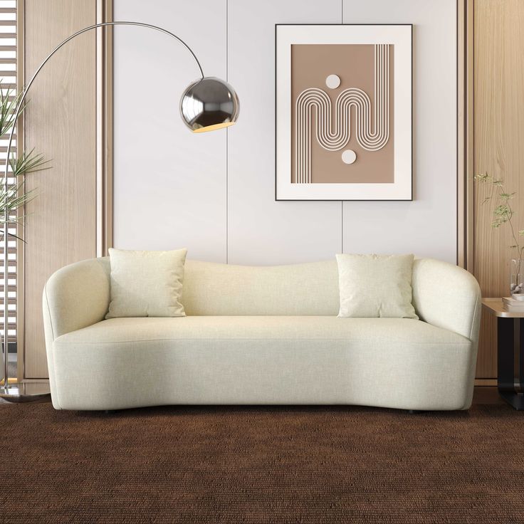 a white couch sitting in a living room on top of a brown carpeted floor