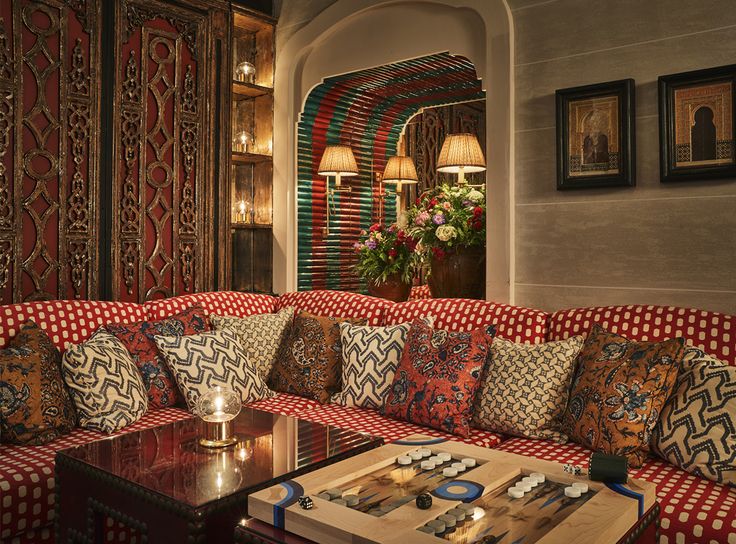 a red and white couch sitting next to a wooden table