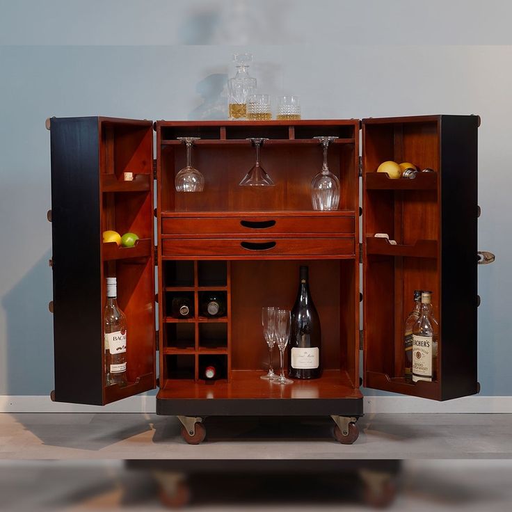 a wooden cabinet with wine glasses and bottles