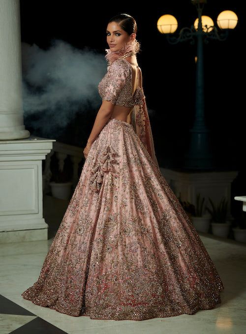 Editor's Note This set is perfect for a traditional bridal look with a modern twist. The rose pink and berry red ombre raw silk lehenga is beautifully embellished with zardozi embroidery, paired with a raw silk embroidered blouse and a tulle dupatta. The intricate embroidery work and stunning ombre color combination make it an ideal choice for a bride who wants to make a statement on her special day. Fabric: Raw silk, tulle Color: Rose pink and red Components: Lehenga, blouse and dupatta Occasio Indian Wedding Dress Bridal Lehenga, Indian Wedding Dress Modern, Silk Bridal Lehenga, Bridal Lehenga Online, Modern Indian Wedding, Bridal Lehenga Designs, Nikkah Dress, Muslim Wedding Dresses, Gothic Wedding Dress