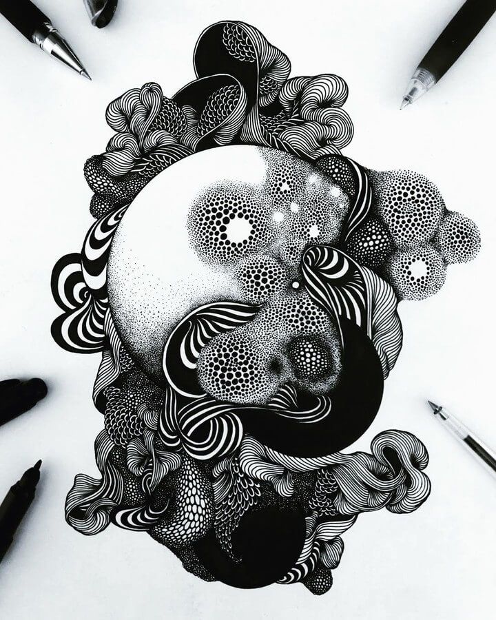 a black and white drawing of a skull surrounded by flowers