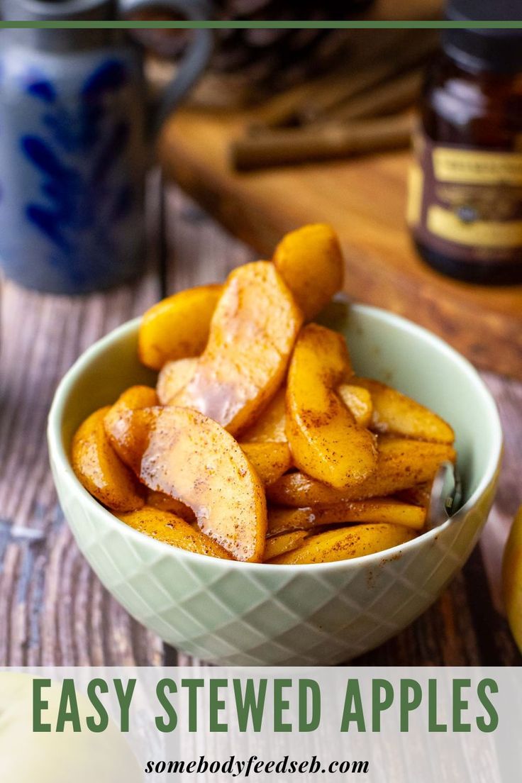 a bowl filled with sliced apples on top of a wooden table