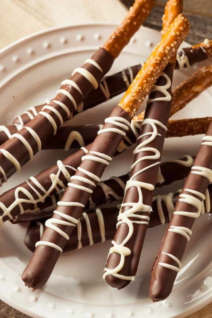 chocolate covered pretzels are arranged on a white plate