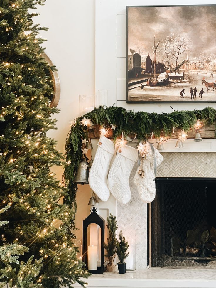 christmas stockings hanging from the mantle in front of a fireplace with a painting on it