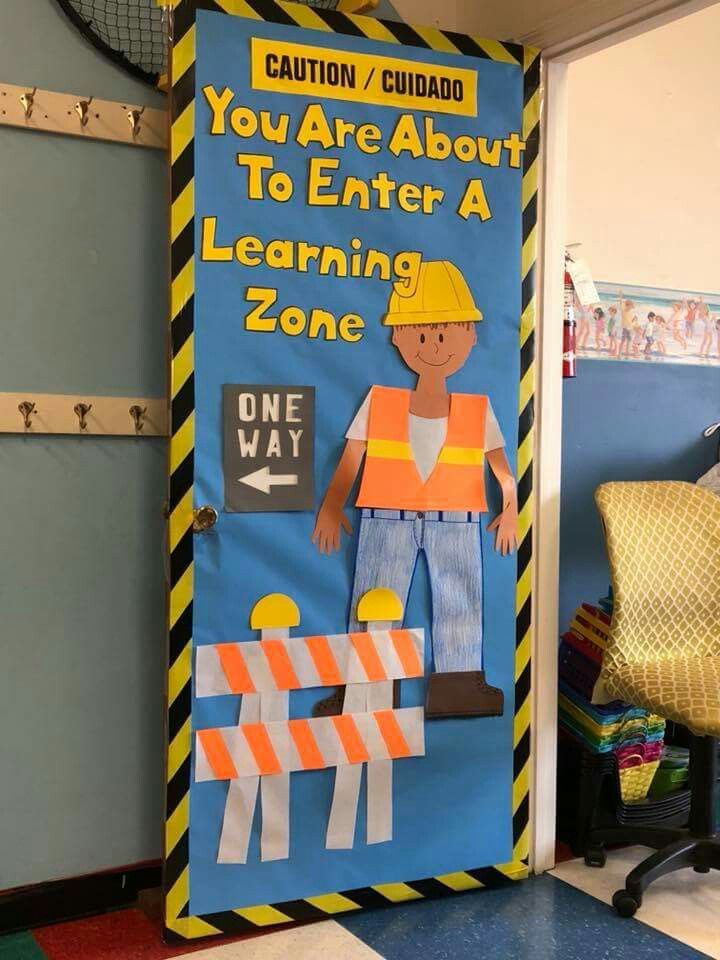 a bulletin board with construction theme on the front and behind it that says you are about to enter a learning zone