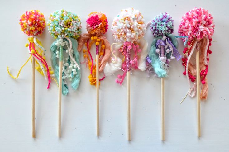 six colorful lollipops are lined up in a row on top of each other