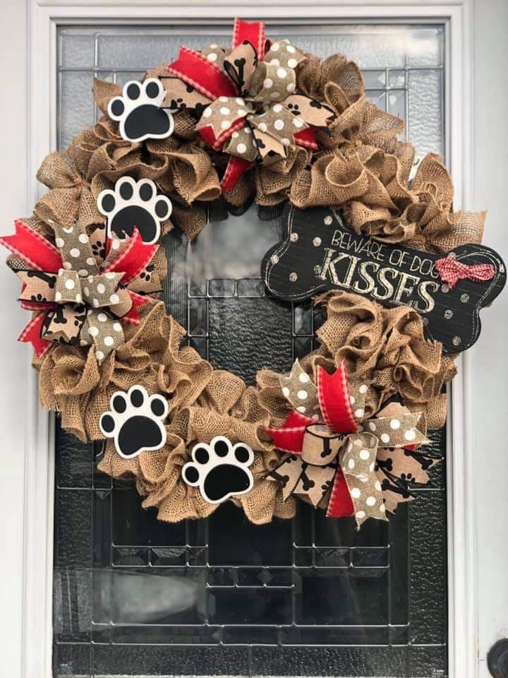 a dog's paw print wreath on the front door