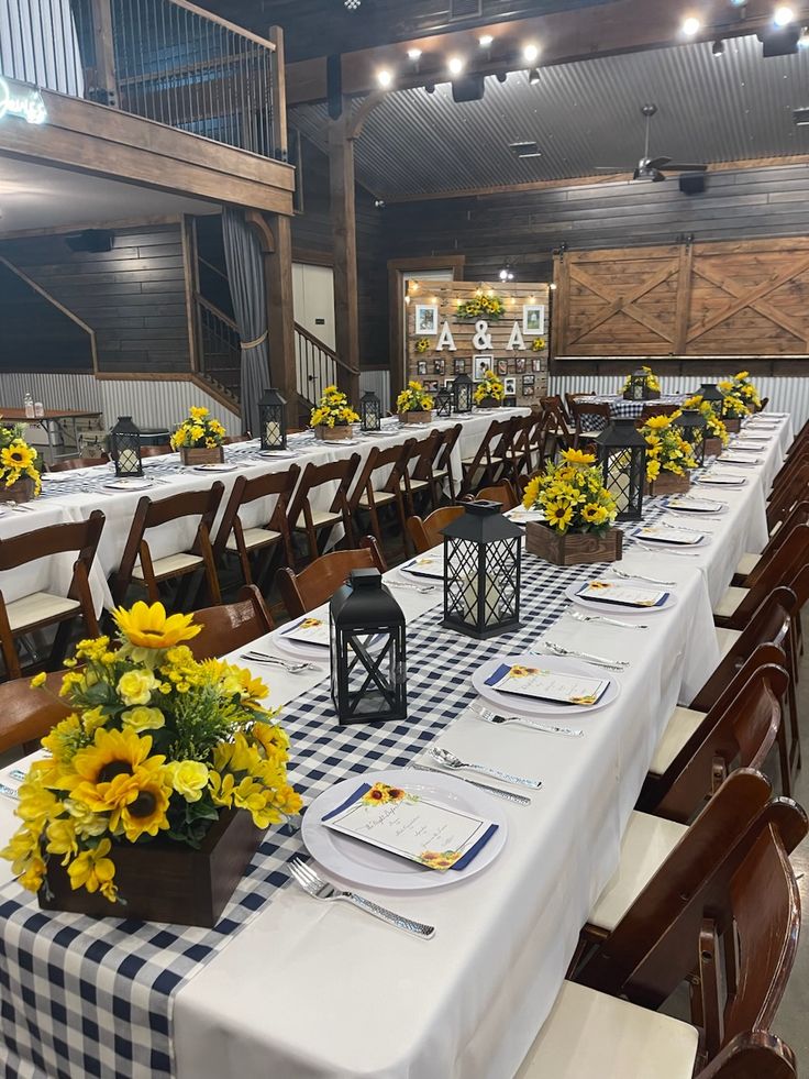 the tables are set with yellow flowers and place settings for guests to sit down at