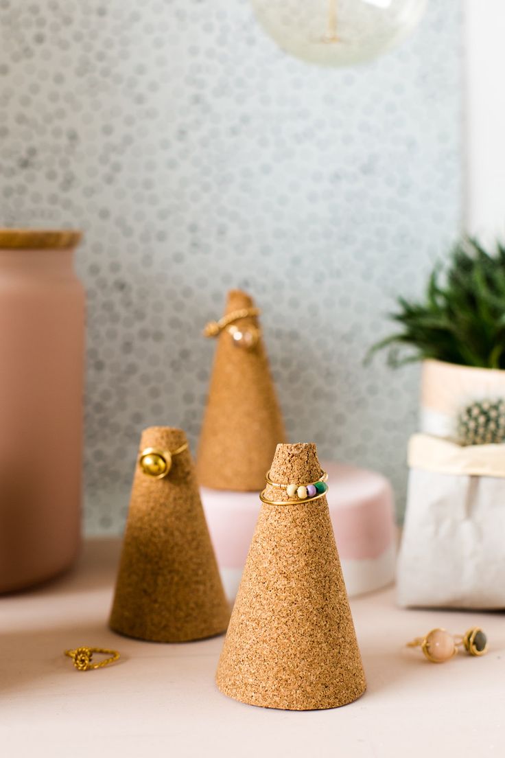 three small gold christmas trees sitting on top of a table