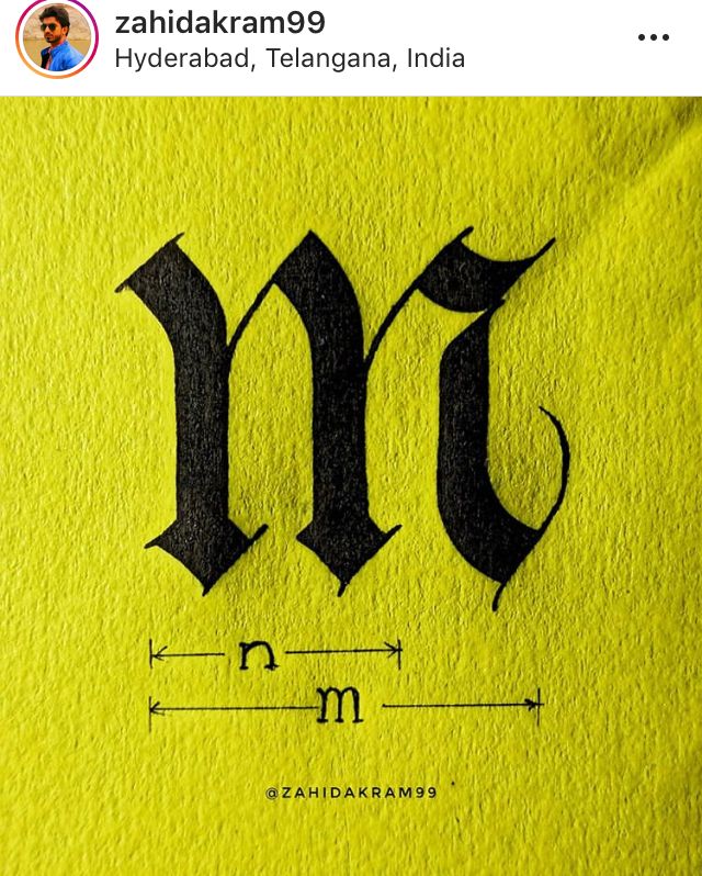 the letter m is made out of paper and has been drawn on it with black ink