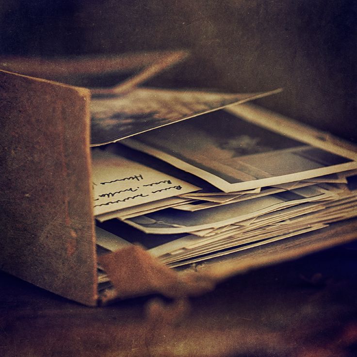 an old book is stacked on top of each other with photos taken from the pages