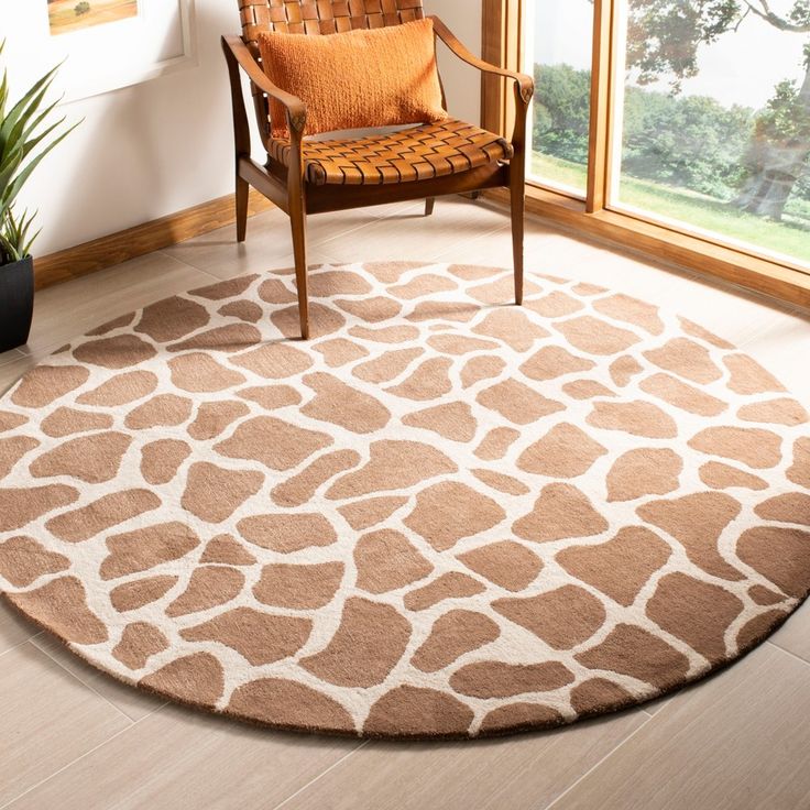 a brown and white area rug with giraffe print on the floor next to a chair