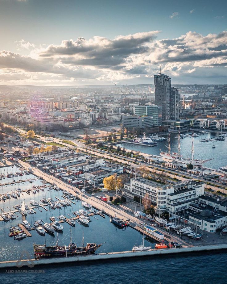 an aerial view of a harbor with boats in the water and buildings on both sides