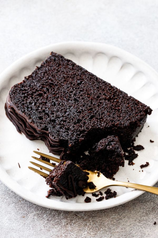 a piece of chocolate cake on a plate with a fork