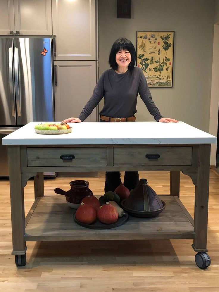 a woman standing in front of a kitchen island