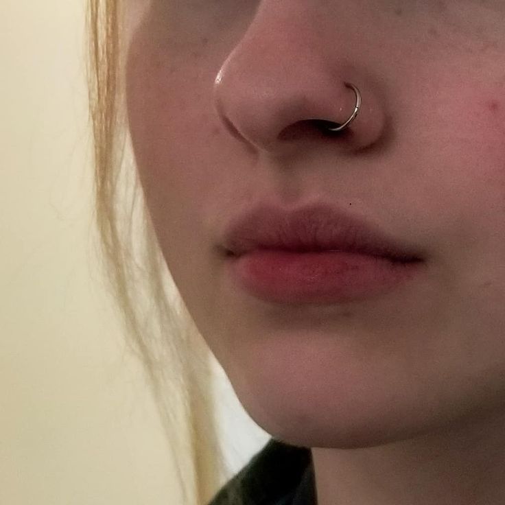 a close up of a person with a nose ring