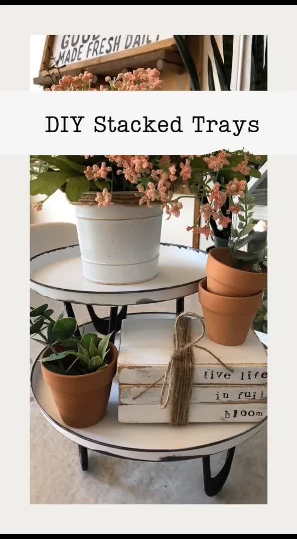 three tiered trays with flowers and books on them