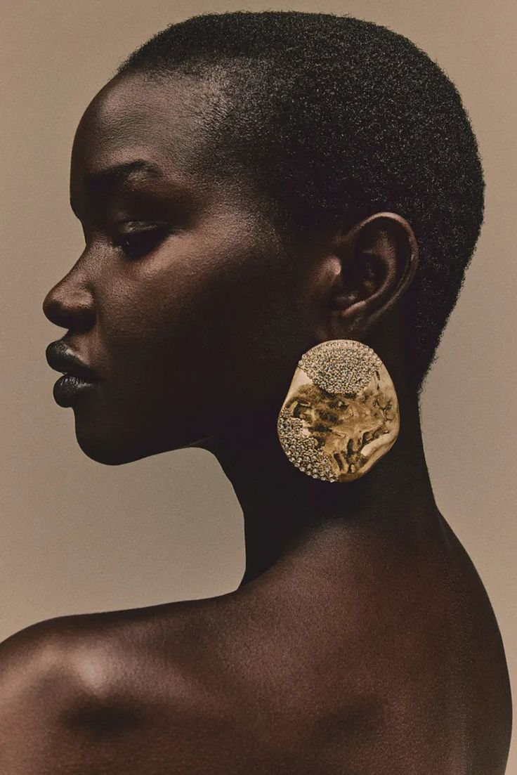 an african woman wearing gold earrings