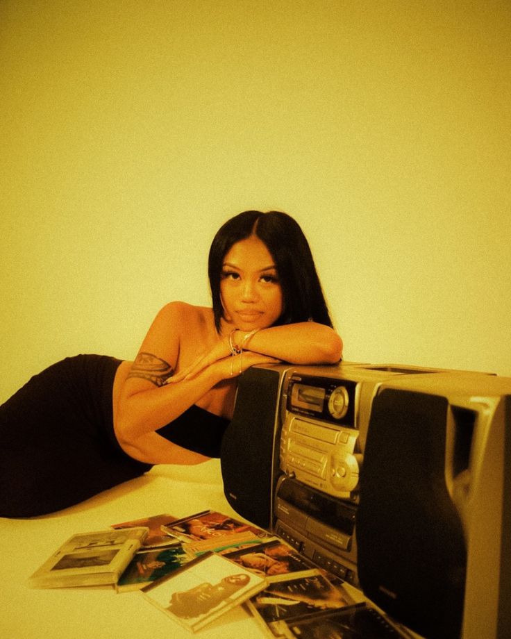 a woman laying on the floor next to a toaster oven with pictures around it