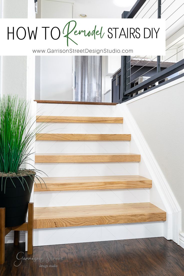 a wooden stair case next to a potted plant