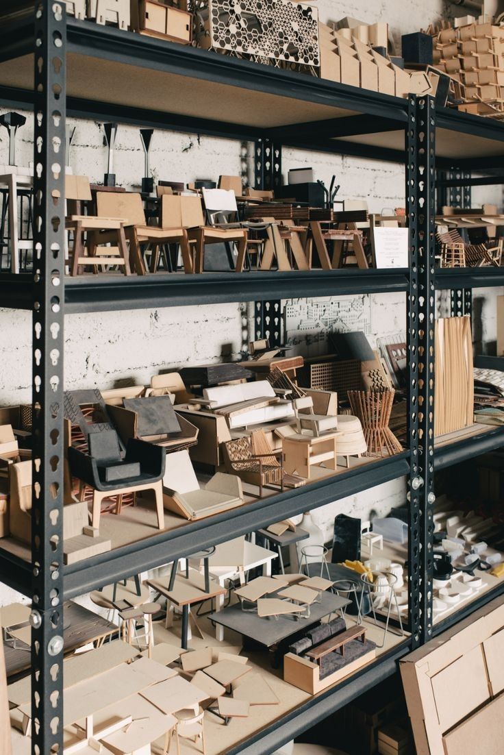 the shelves are filled with various types of wooden furniture and boxes on them, all stacked together