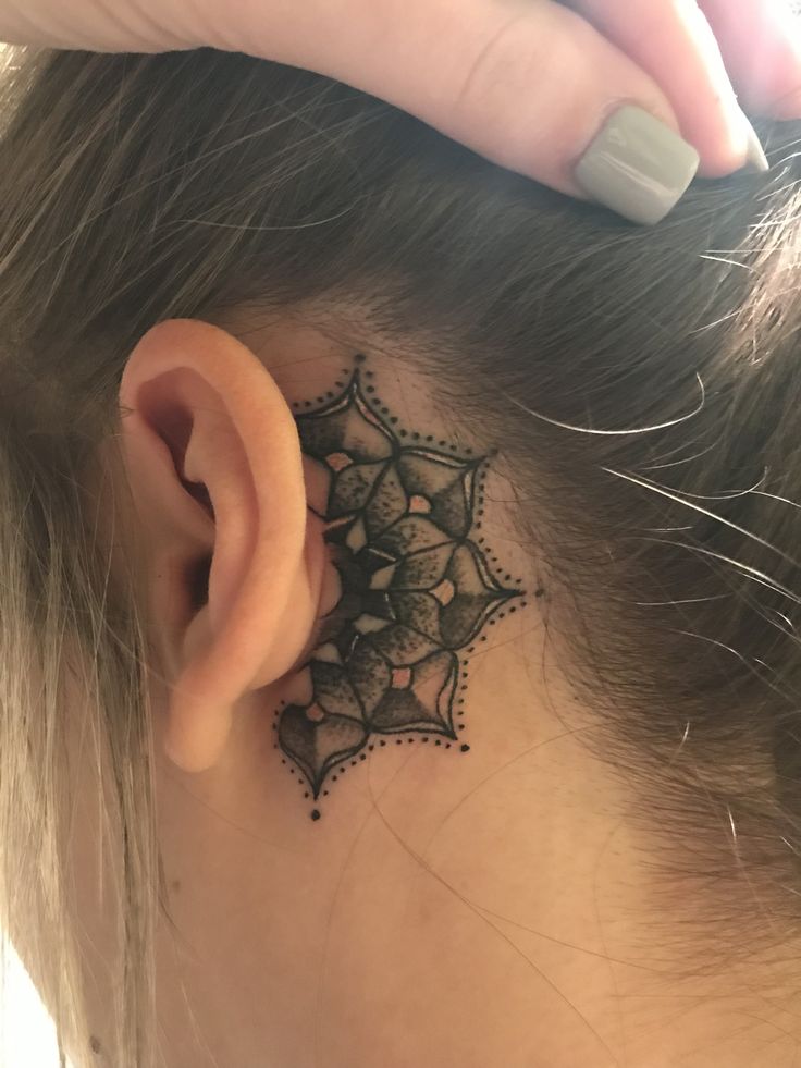 a woman with a tattoo on her ear