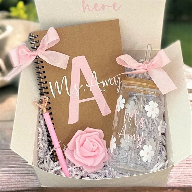 a gift box filled with personalized items and a notepad