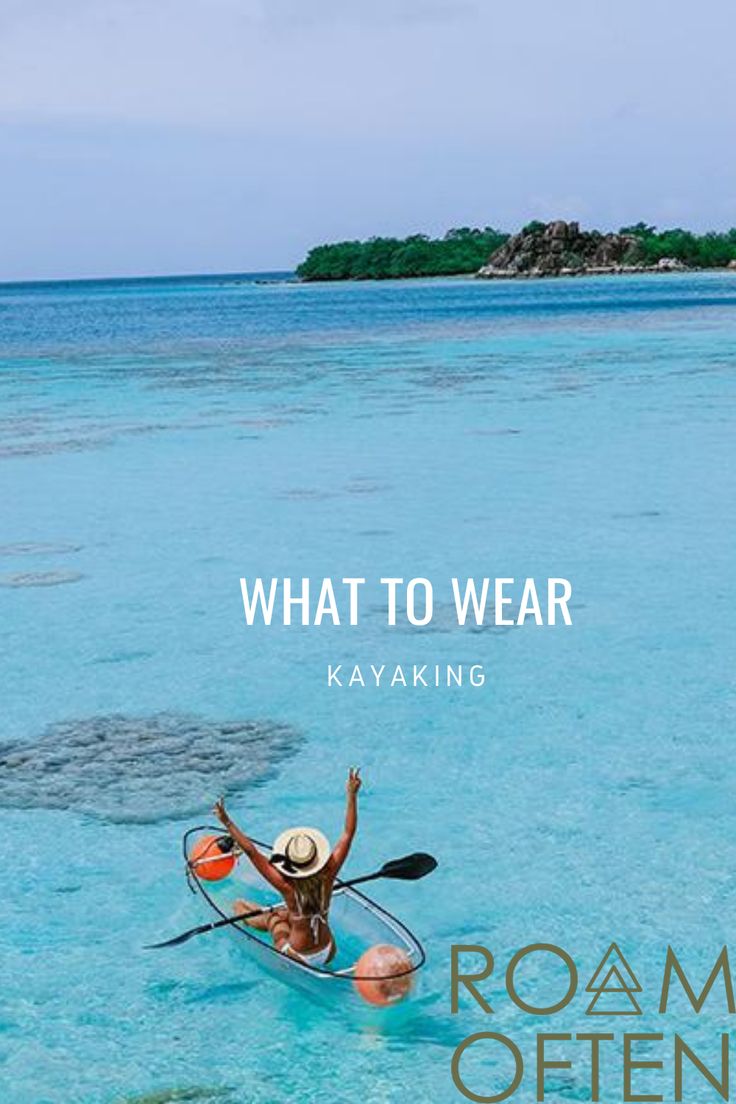 a person in a kayak with the words what to wear on it and an island in the background