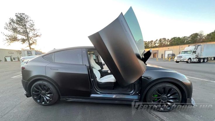 a car with its door open in a parking lot