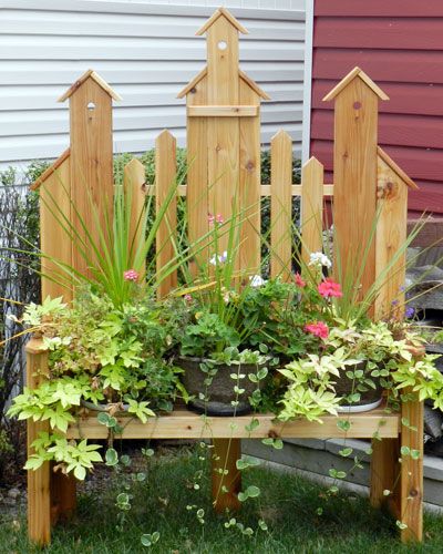 a wooden bench with plants growing in it