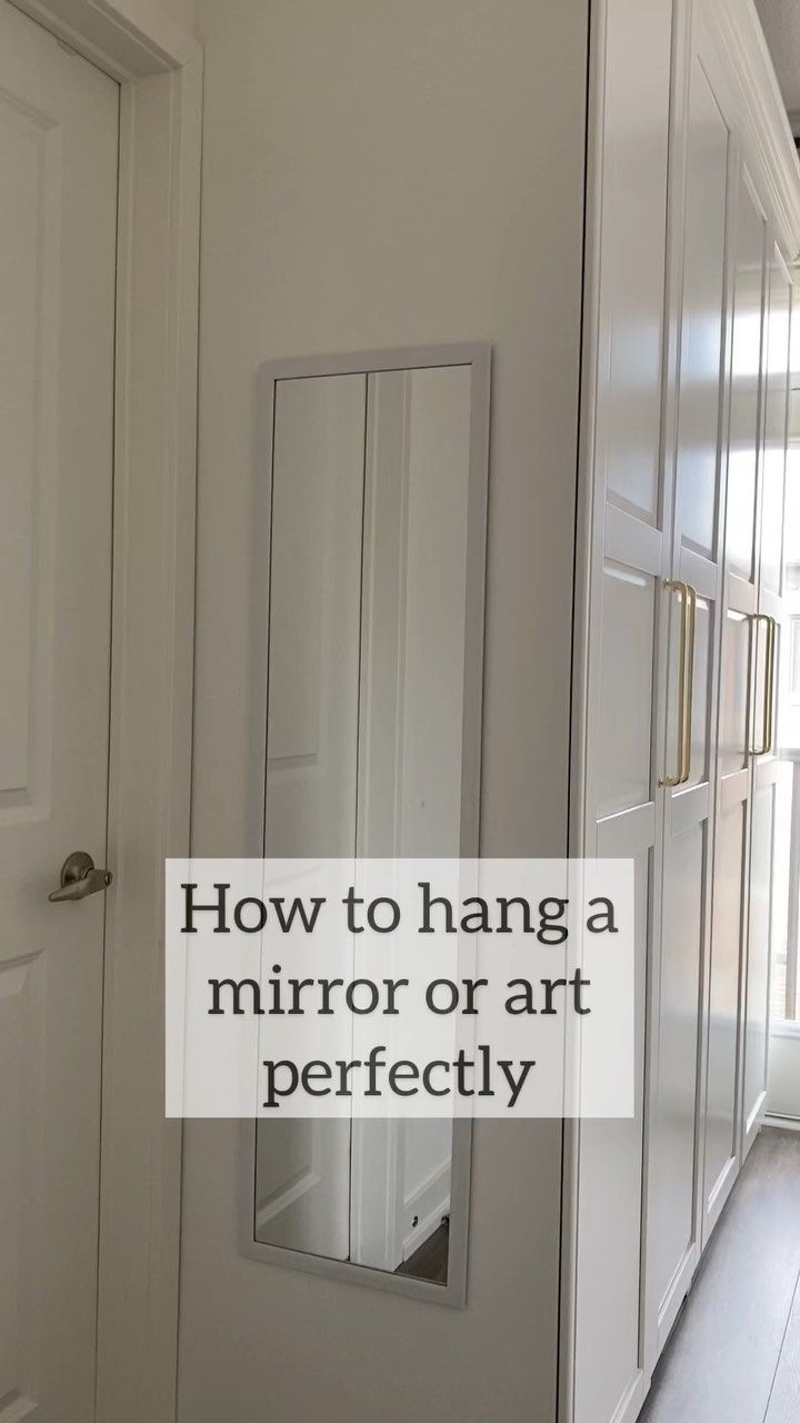 an empty hallway with white walls and wooden floors is featured in the article how to hang a mirror or art perfectly