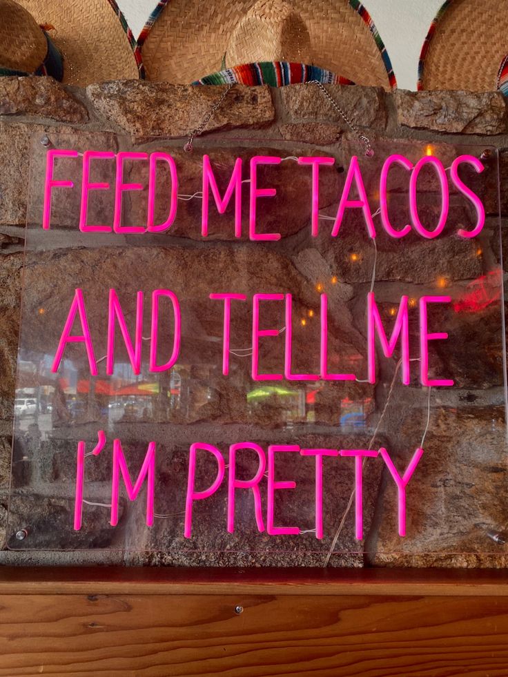 there is a sign that says feed me tacos and tell me i'm pretty