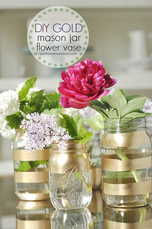 three mason jars with flowers in them sitting on a table