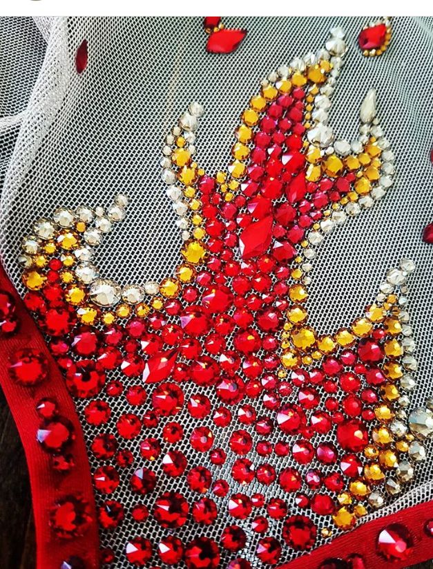 red and yellow sequins on white mesh with beads in the shape of a peacock