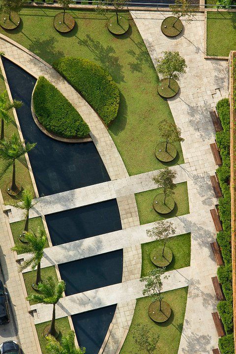 an aerial view of a park with water and trees