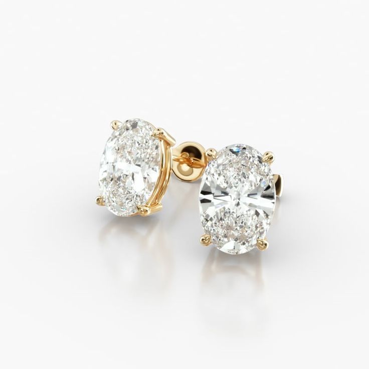 These 14K Yellow Gold Oval Shape Diamond Stud Earrings are a classic and elegant pair of earrings that are sure to make a statement. The oval-shaped diamonds are set in a tapered basket that showcases their beauty. The 14K yellow gold setting gives them a timeless look. It is durable and tarnish-resistant, and will keep your earrings looking their best for years to come. The diamonds in these earrings are 2.00 carats total weight. They are H-I color and SI1-SI2 clarity. These earrings are perfec Shimmer N Shine, Yellow Gold Setting, Diamond Stud Earrings, Diamond Stud, Fine Jewellery Earrings, Diamond Earrings Studs, Diamond Studs, Oval Shape, Diamond Shapes