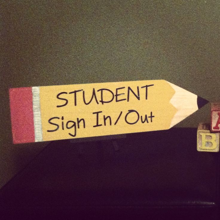 a sign that says student sign in / out with a pencil sticking out of it