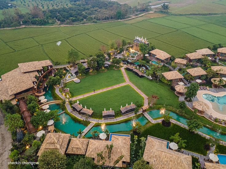 an aerial view of a resort surrounded by lush green fields