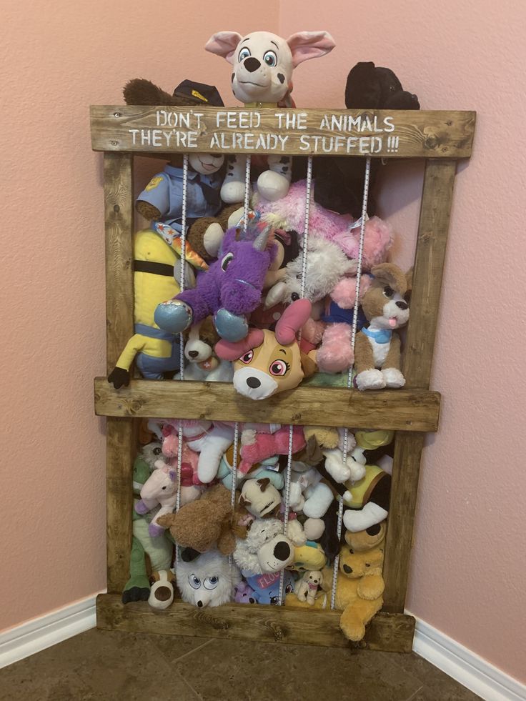 stuffed animals are on display in a wooden crate with the words, tiny feed me animals they're already stuffed