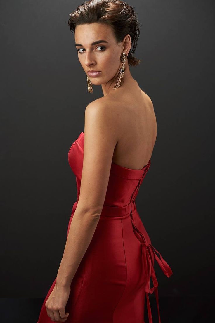 a woman in a red dress posing for a photo