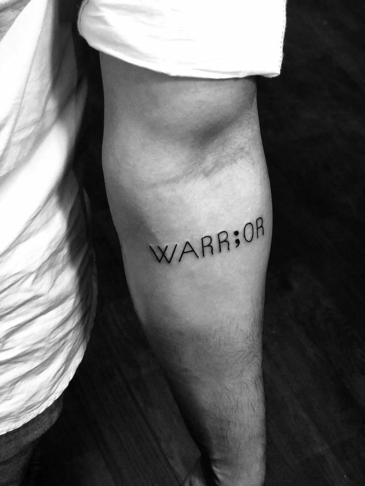 a man with a tattoo on his arm that says,'warrior'in black ink