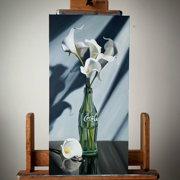 a painting of flowers in a coke bottle on an easel next to a white flower