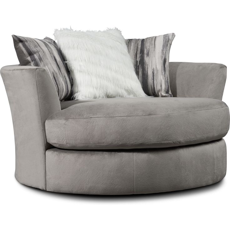 a large gray chair with pillows on it's back and side rests against a white background